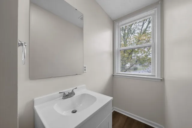 a bathroom with a sink and a window