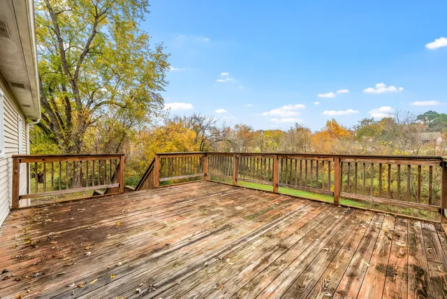 a view of balcony with wooden floor and fence