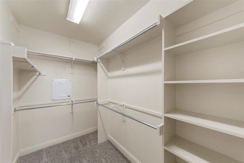 7929 Maddox Road Plano, TX 75024 - Photo 10 of 26 Primary closet in ensuite with shelving.