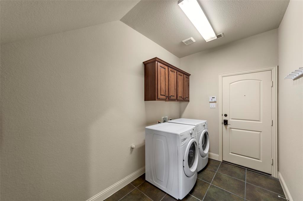 7929 Maddox Road Plano, TX 75024 - Photo 17 of 26 If you love doing laundry or not, this space has lots of room for folding table or storage. Door leads to spacious 2 car garage with high ceilings.