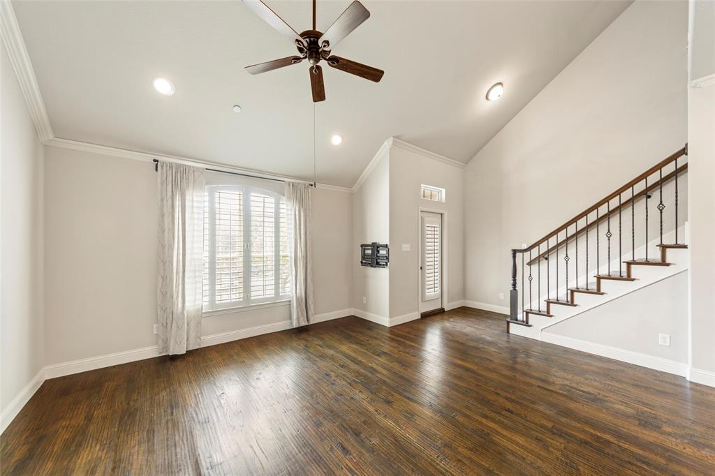 7929 Maddox Road Plano, TX 75024 - Photo 5 of 26 2nd level open concept living space with plantation shutters. Door leads to quaint covered balcony with park view. Stairs lead to wonderful 3rd level with endless possibilities. Plus larger covered balcony and half bath.