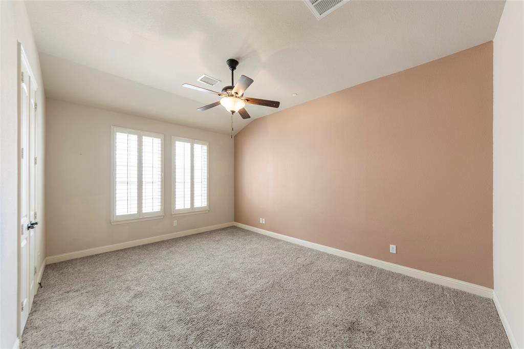 7929 Maddox Road Plano, TX 75024 - Photo 7 of 26 Spacious primary bedroom with ensuite, plantation shutters & ceiling fan.