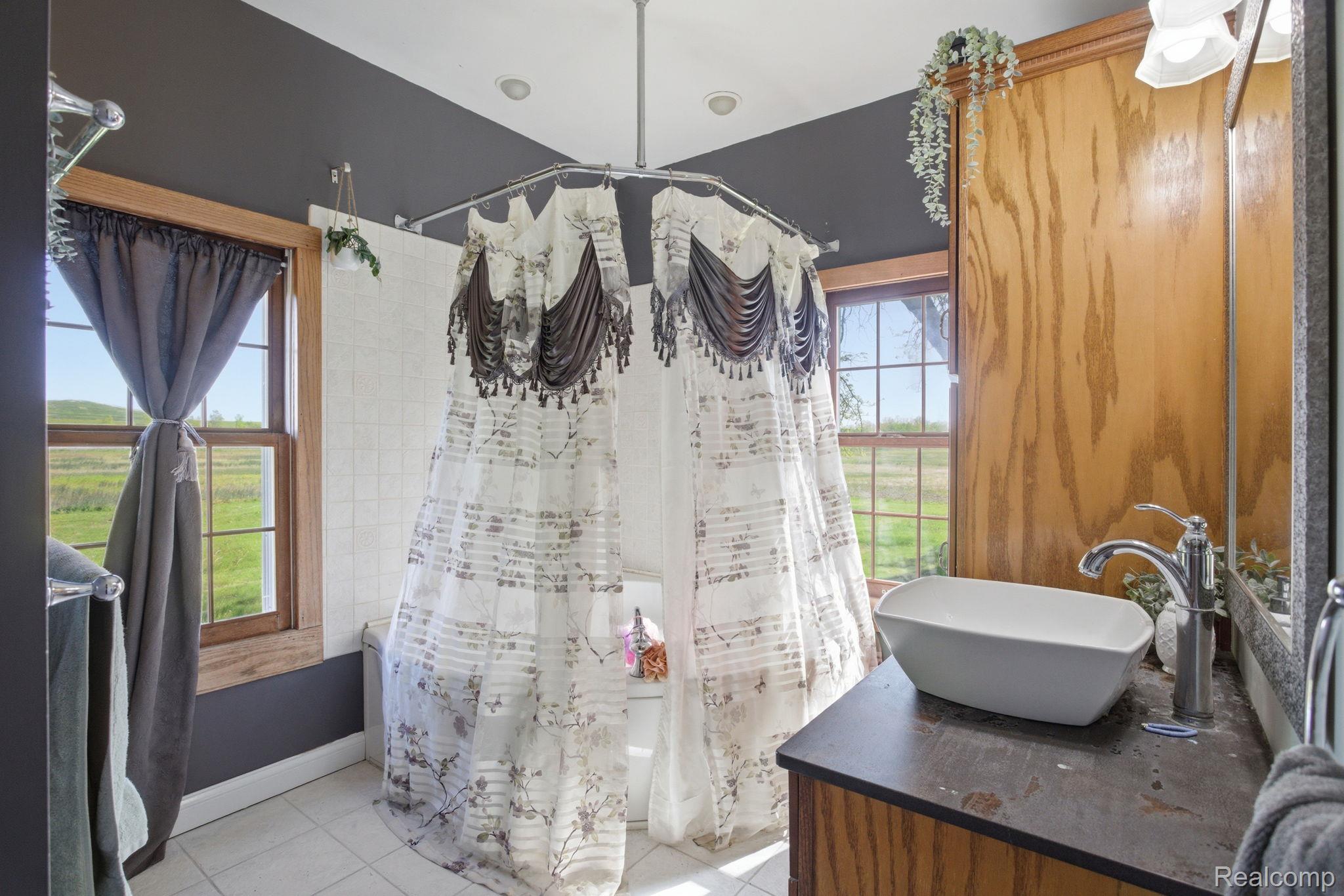 14104 Carleton West Road Carleton, MI 48117 - Photo 23 of 58 Bathroom featuring vanity, a shower with curtain, and light tile patterned floors