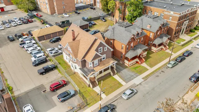 an aerial view of residential house with parking