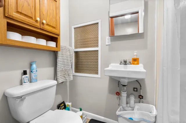 a white toilet sitting next to a bathroom sink
