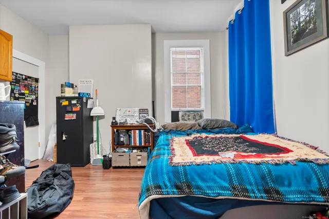 a bedroom with a bed and a window