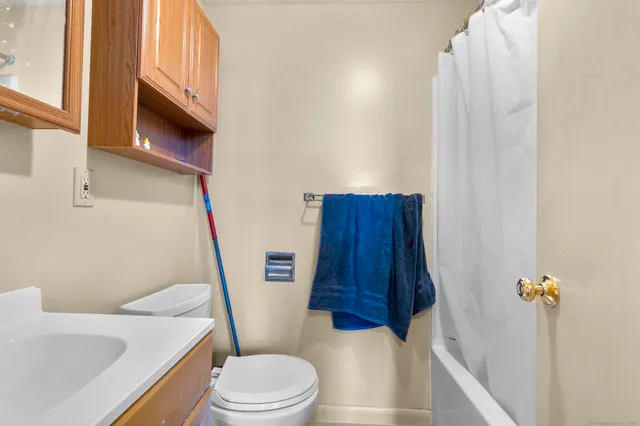 a bedroom with a bed and a tv