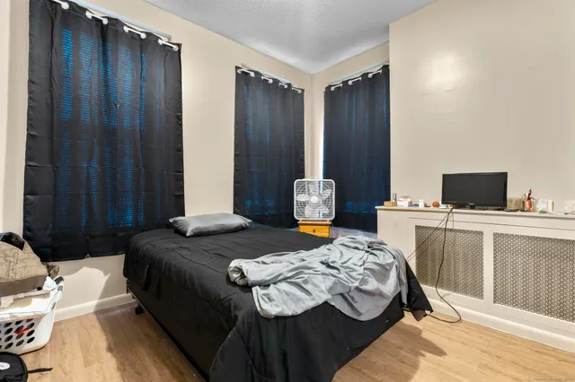 a view of a kitchen with refrigerator and wooden floor
