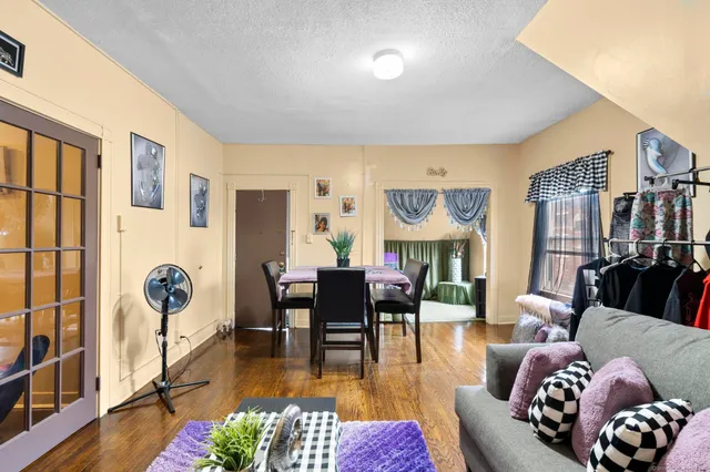 a living room with furniture fireplace and wooden floor