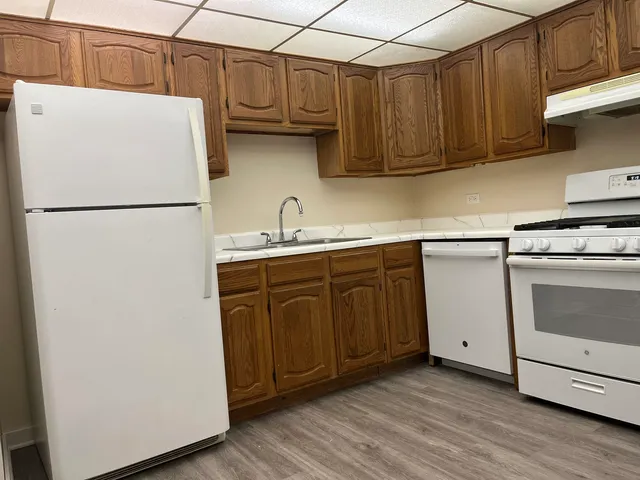 a kitchen with stainless steel appliances granite countertop a stove a microwave and cabinets