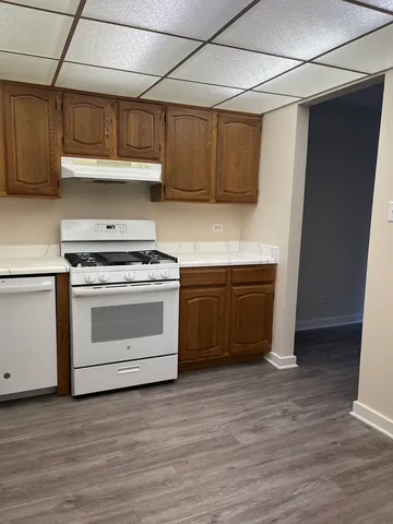 a kitchen with stainless steel appliances granite countertop a sink and a refrigerator