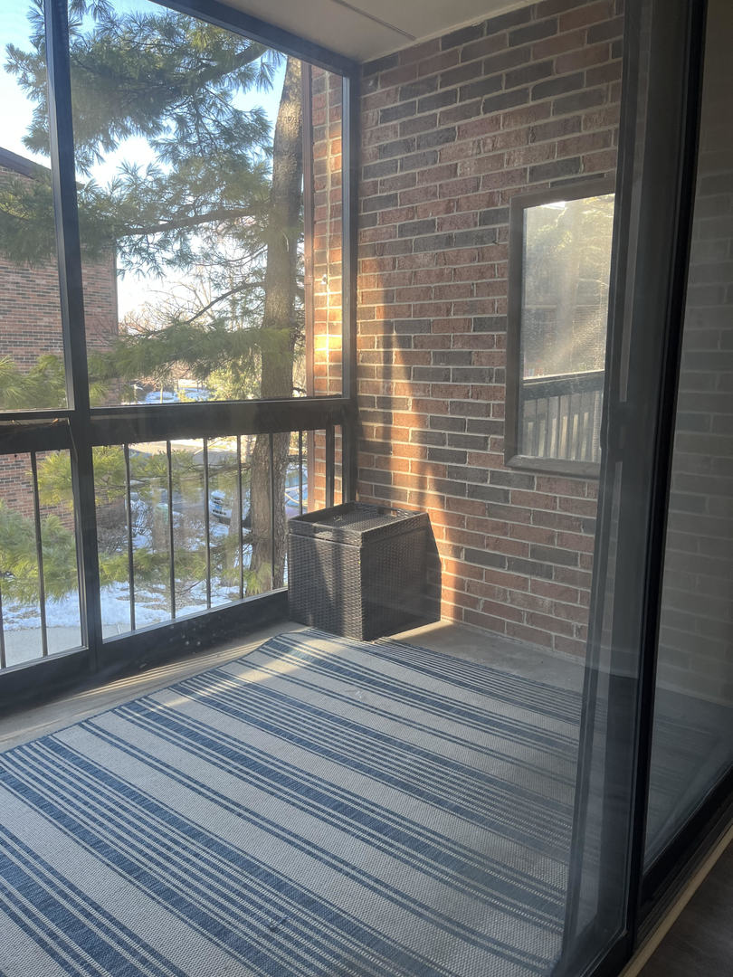 5515 Cromwell Lane, Unit M2 Oak Forest, IL 60452 - Photo 23 of 25 a view of an empty room with wooden floor and a window