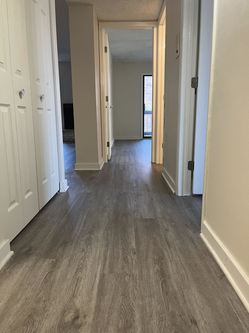 5515 Cromwell Lane, Unit M2 Oak Forest, IL 60452 - Photo 7 of 25 a view of a hallway with wooden floor