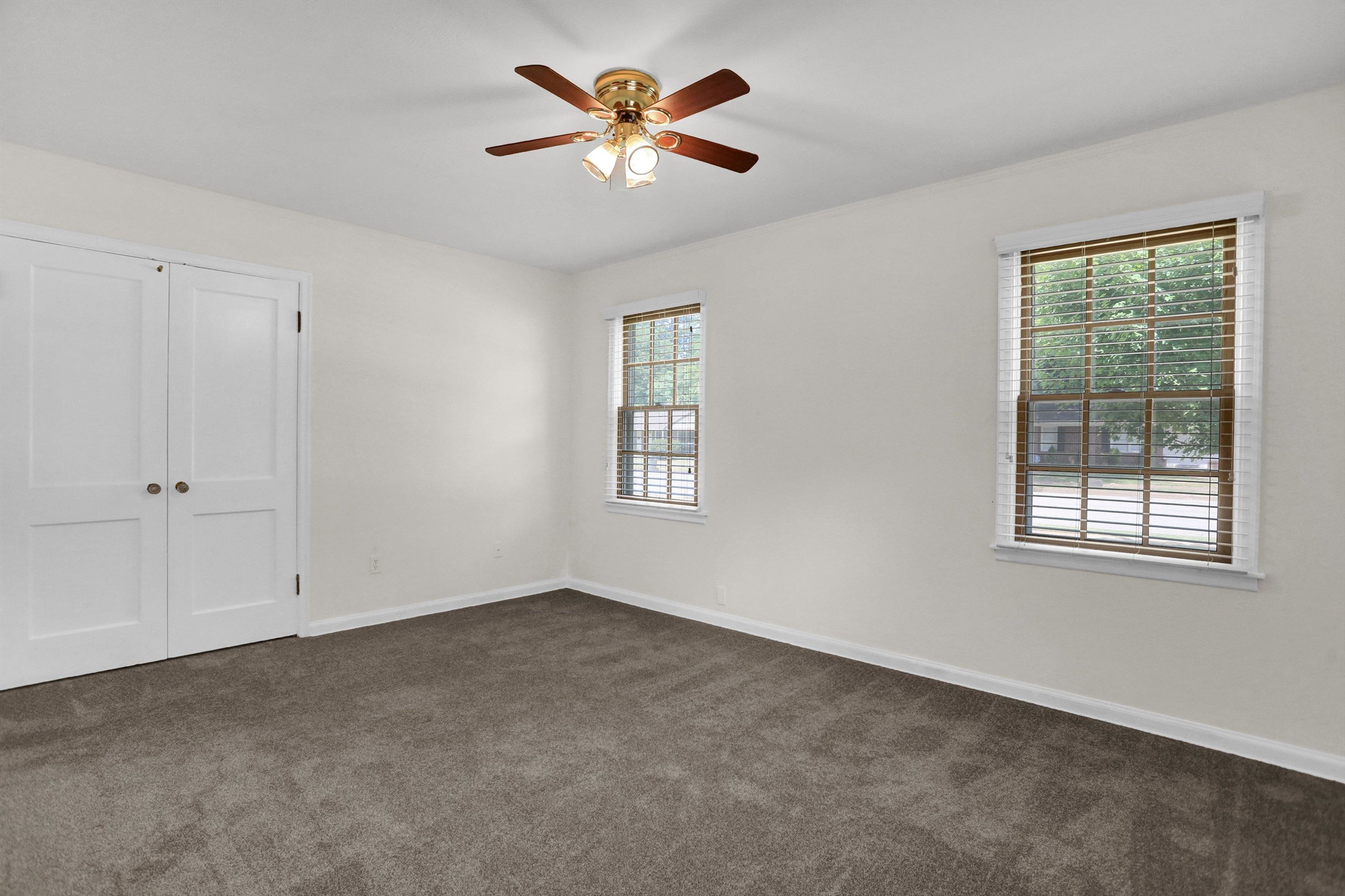 4545 Flamingo Road Memphis, TN 38117 - Photo 26 of 34 Carpeted room featuring two windows with horizontal blinds and a ceiling fan with light fixture