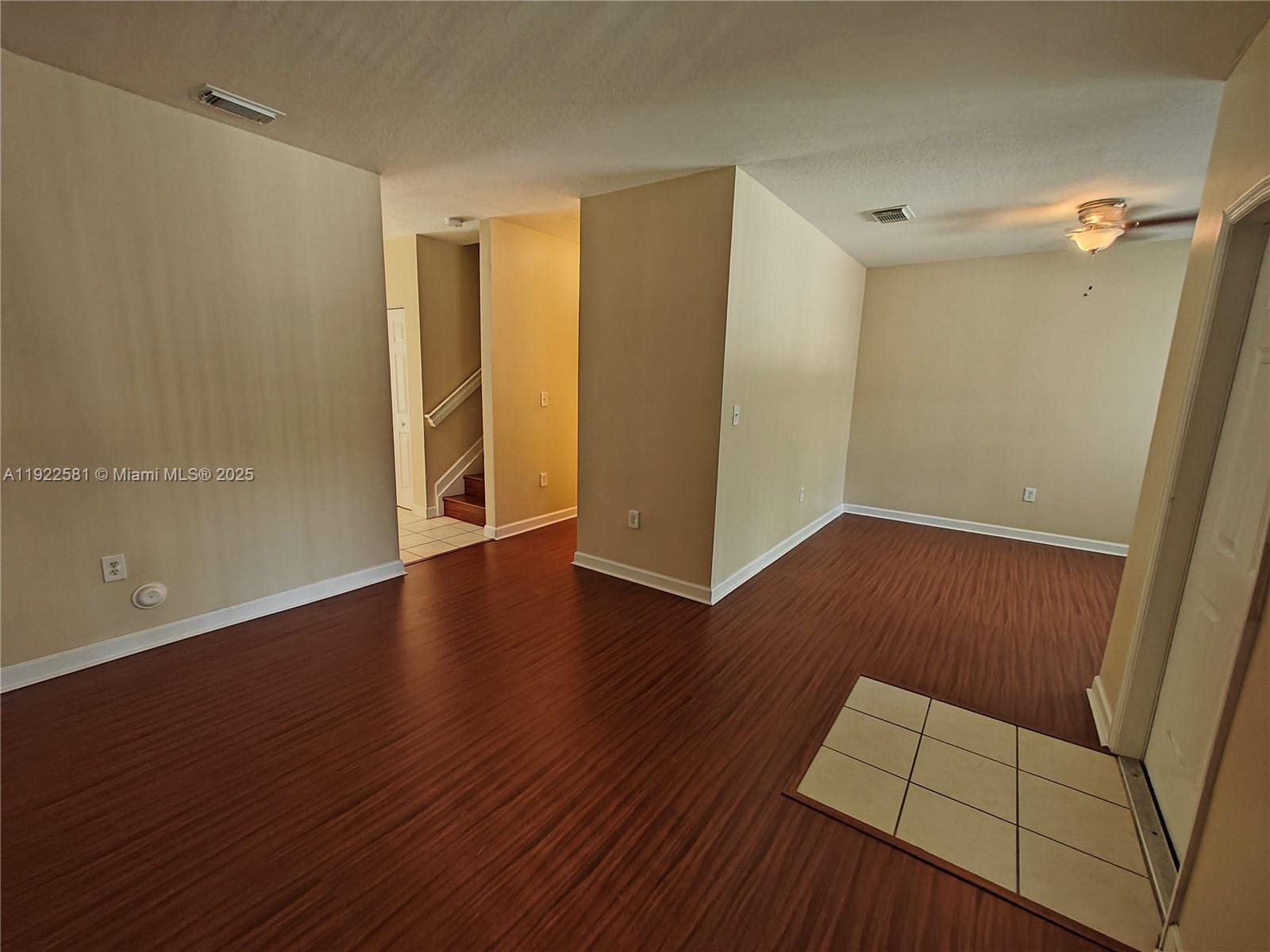 11252 Southwest 230th Terrace, Unit 11252 Miami, FL 33170 - Photo 4 of 28 an empty room with wooden floor and windows