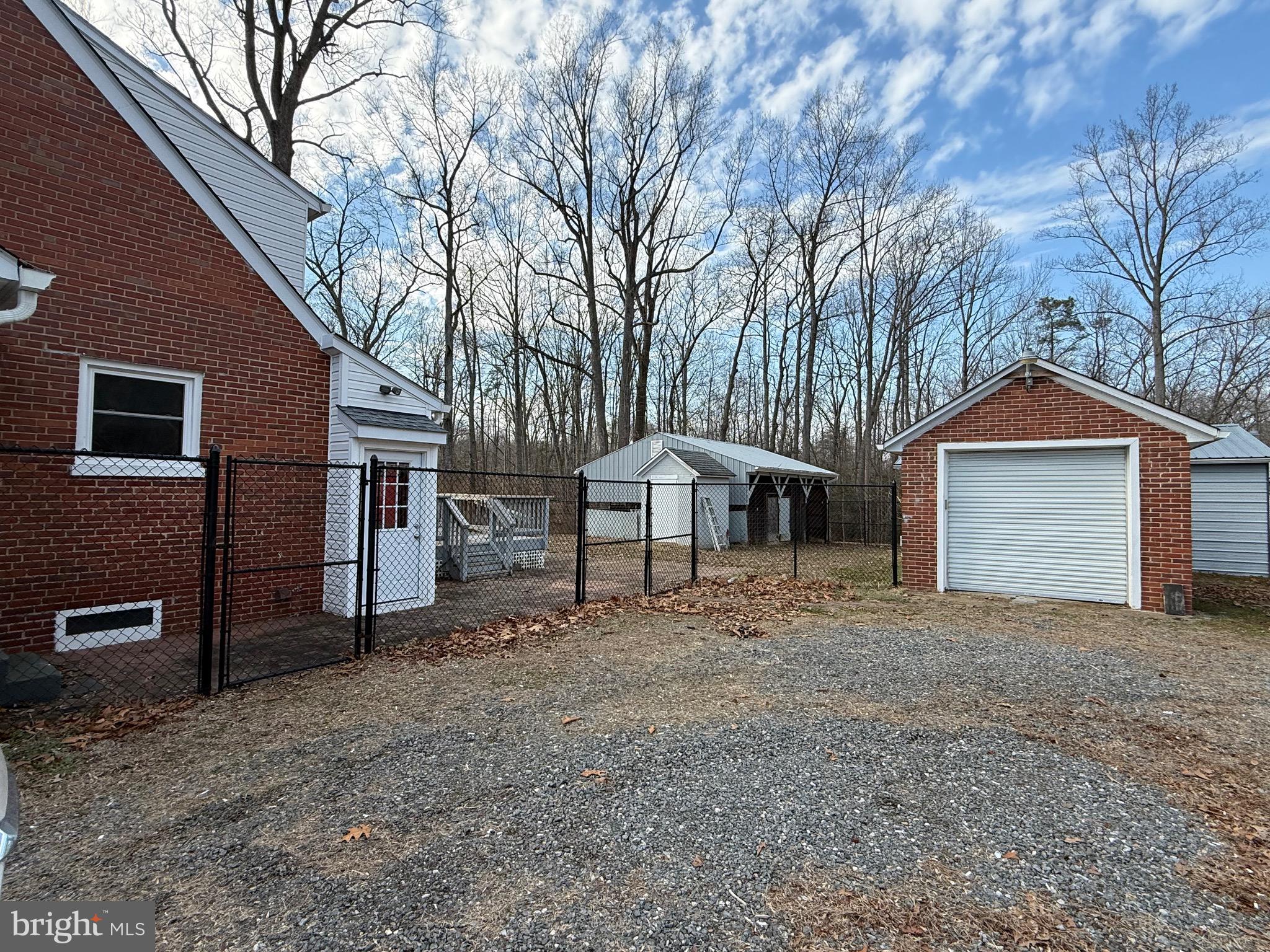 9253 Dahlgren Road King George, VA 22485 - Photo 4 of 23 a front view of a house with a yard and garage
