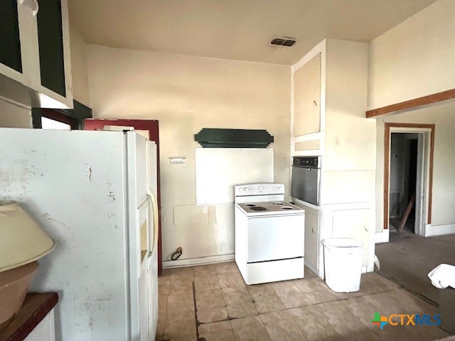206 Hinton Street Three Rivers, TX 78071 - Photo 12 of 34 a kitchen with a refrigerator and a stove