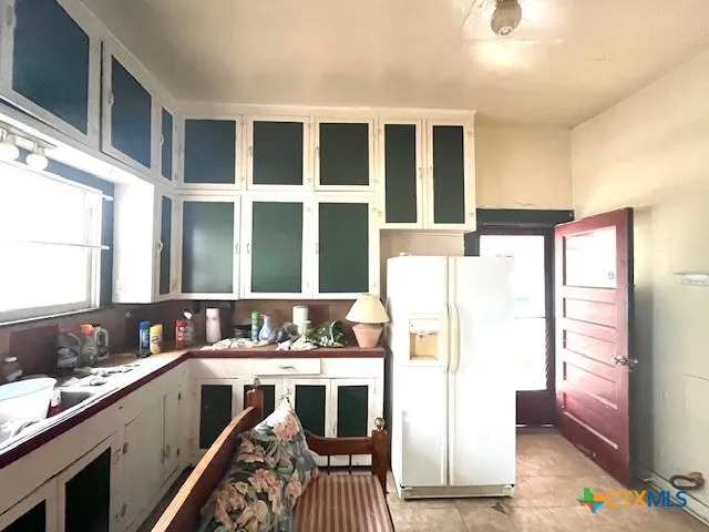 a living room with two couches a dining table and chairs with wooden floor