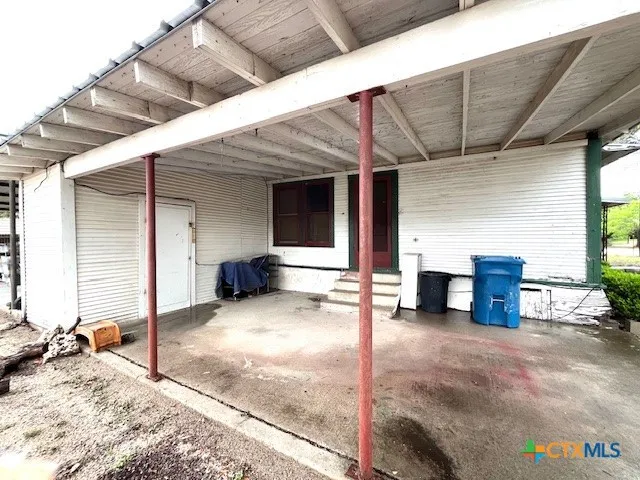 a view of a house with cars park