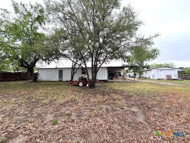 a view of a house with a yard and sitting area