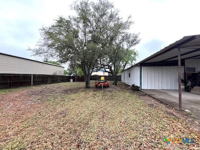 a kitchen with a appliances a window and a counter top space