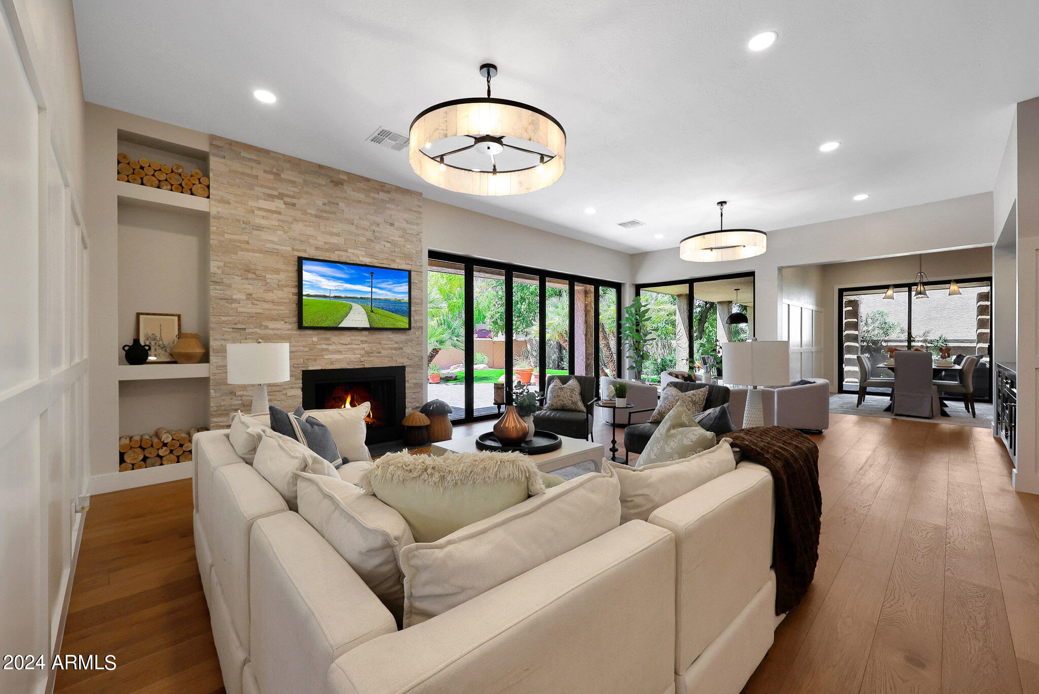 a living room with fireplace furniture and a large window