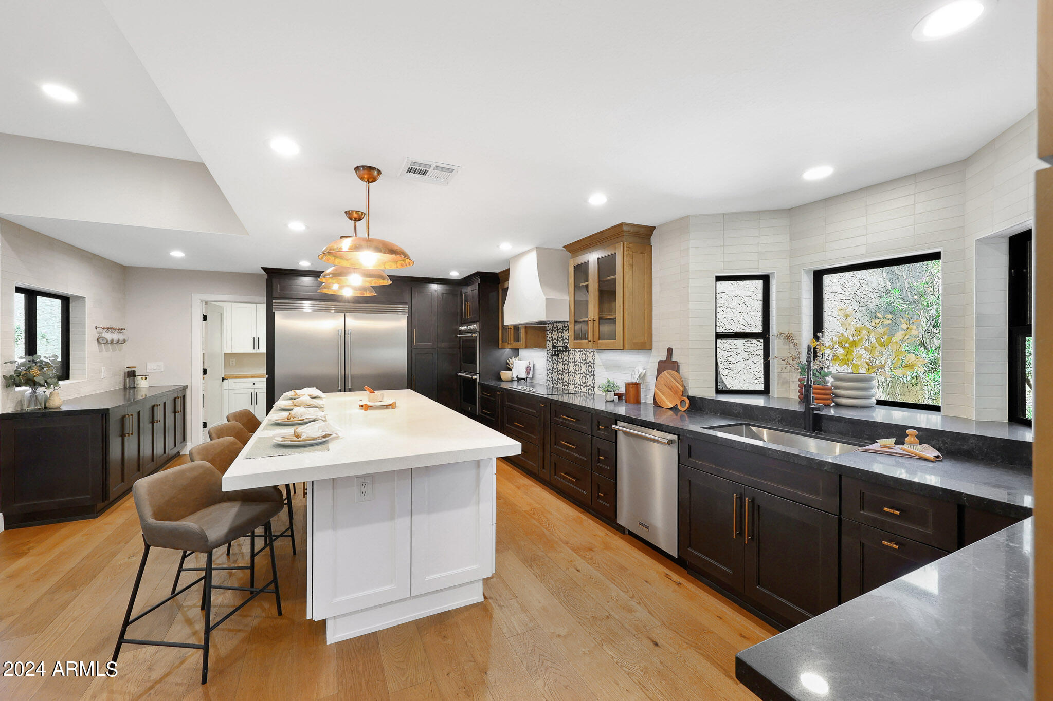 4440 East Camelback Road, Unit 32 Phoenix, AZ 85018 - Photo 20 of 54 a kitchen with kitchen island granite countertop a sink and stove