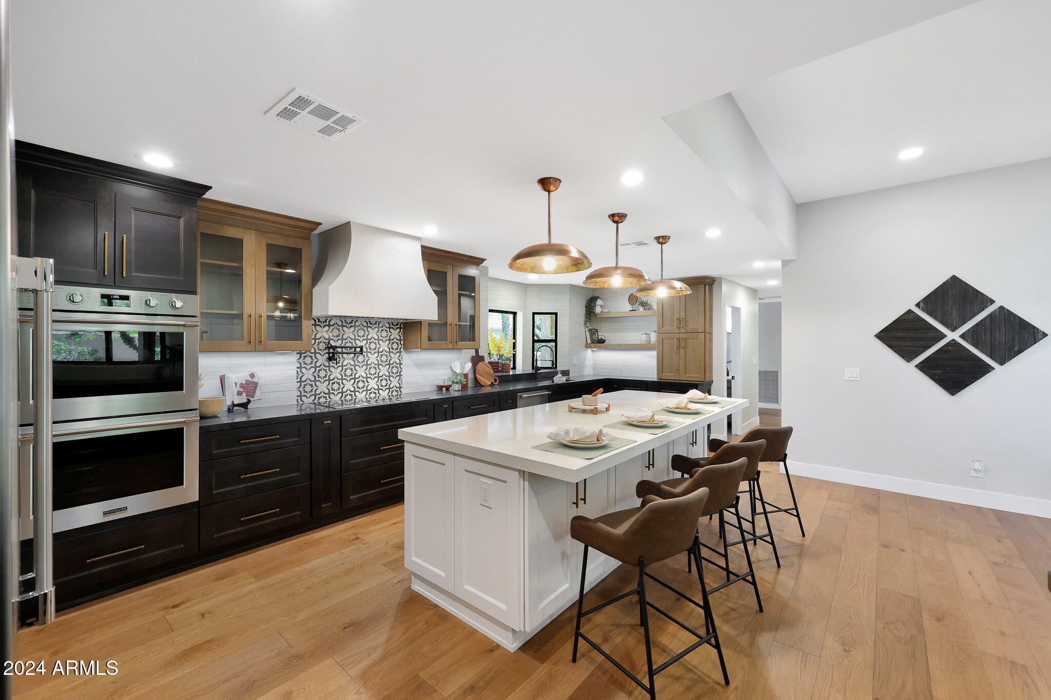4440 East Camelback Road, Unit 32 Phoenix, AZ 85018 - Photo 2 of 54 a kitchen with stainless steel appliances kitchen island granite countertop a stove a sink and a microwave