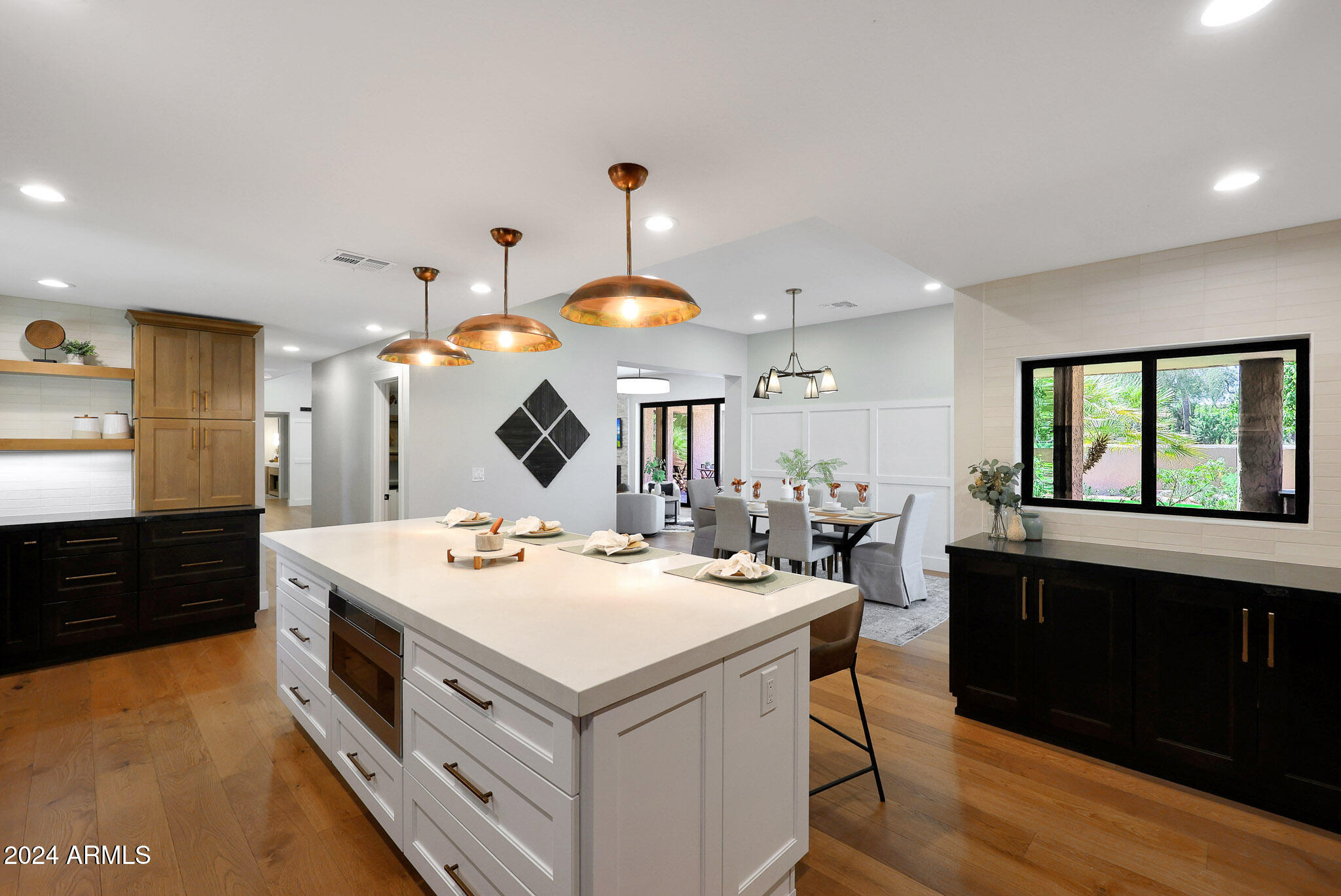4440 East Camelback Road, Unit 32 Phoenix, AZ 85018 - Photo 21 of 54 a kitchen with a sink a stove a dining table and chairs