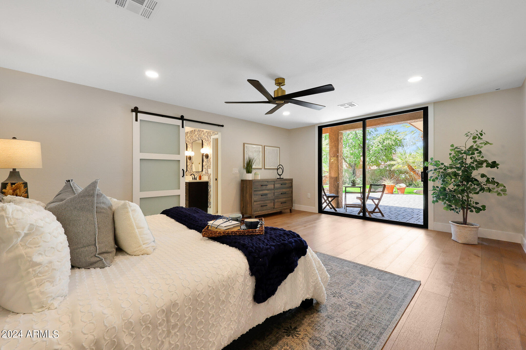 4440 East Camelback Road, Unit 32 Phoenix, AZ 85018 - Photo 28 of 54 a bedroom with a large bed and a large window