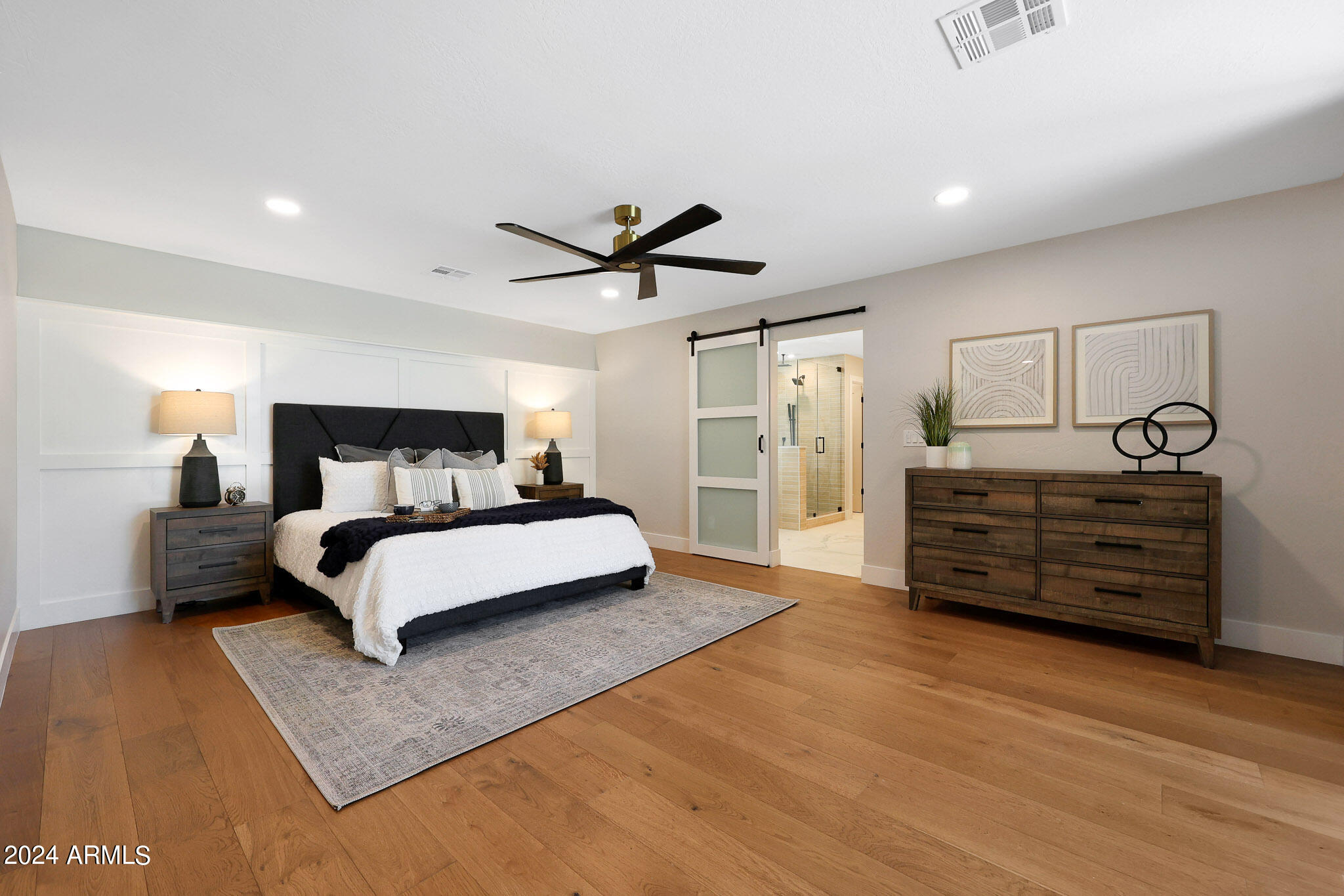 4440 East Camelback Road, Unit 32 Phoenix, AZ 85018 - Photo 29 of 54 a bedroom with a large bed and a chandelier