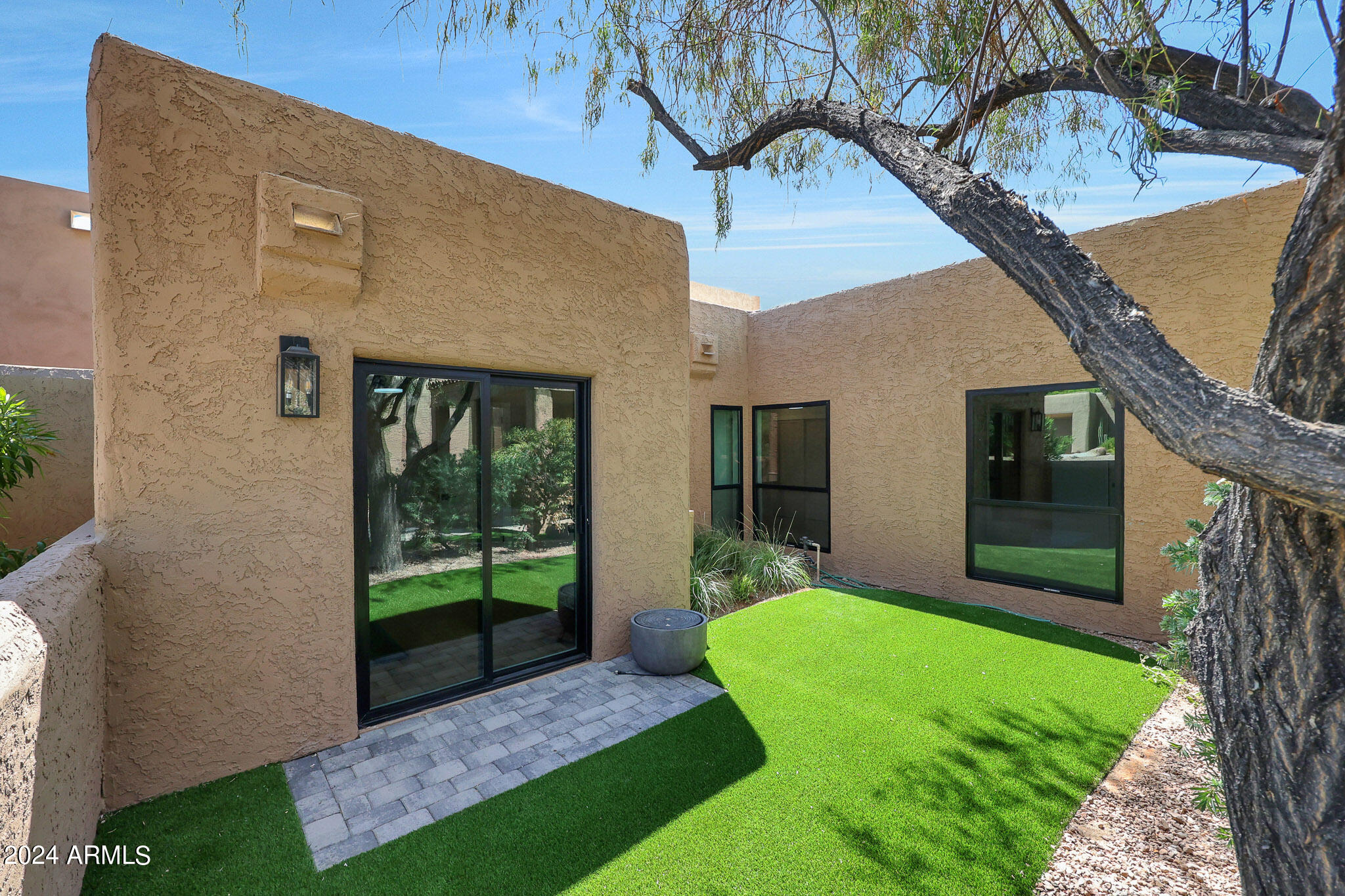 4440 East Camelback Road, Unit 32 Phoenix, AZ 85018 - Photo 34 of 54 a front view of a house with a yard table and outdoor seating
