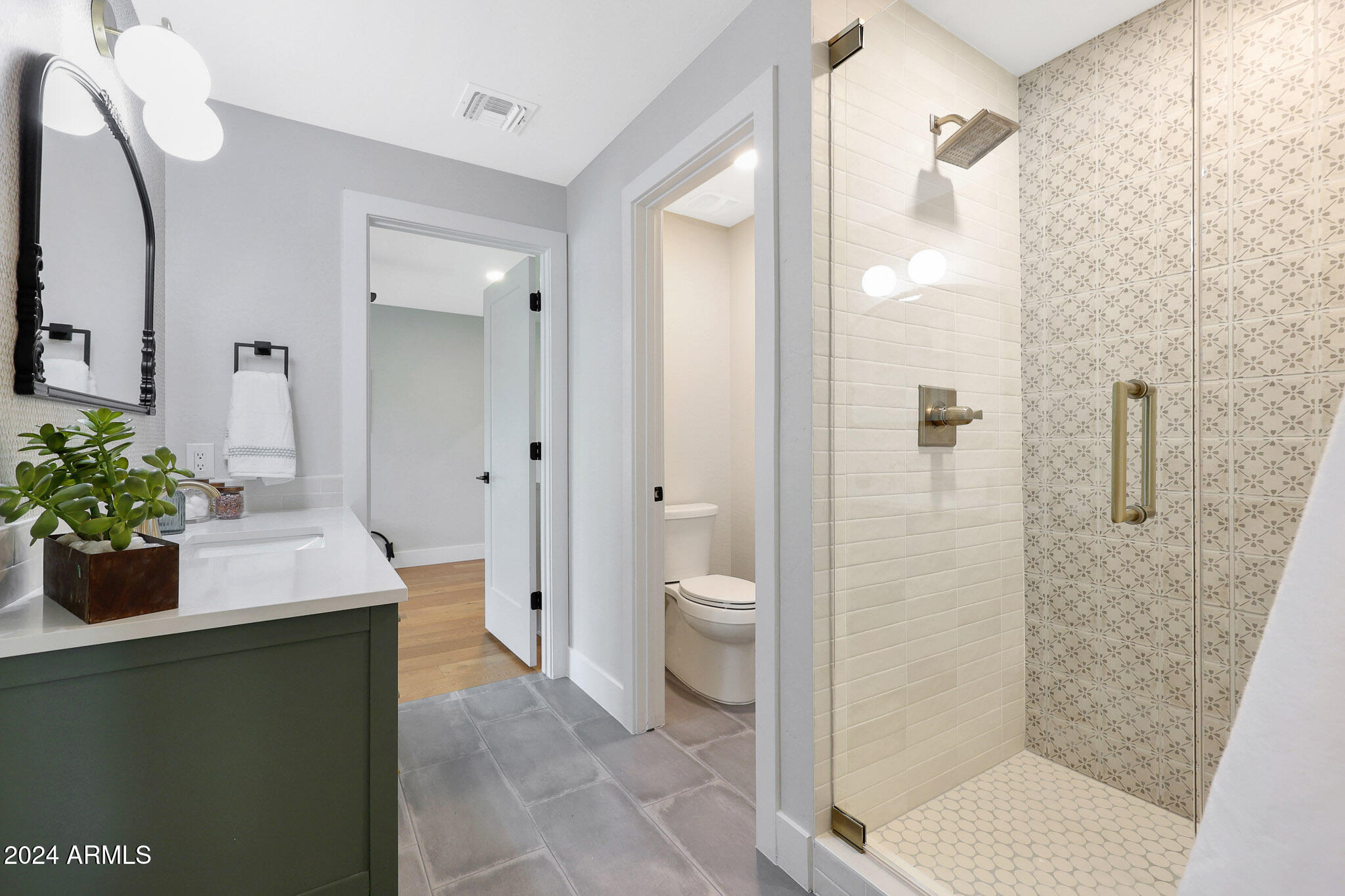 4440 East Camelback Road, Unit 32 Phoenix, AZ 85018 - Photo 37 of 54 a bathroom with a granite countertop sink a toilet and shower