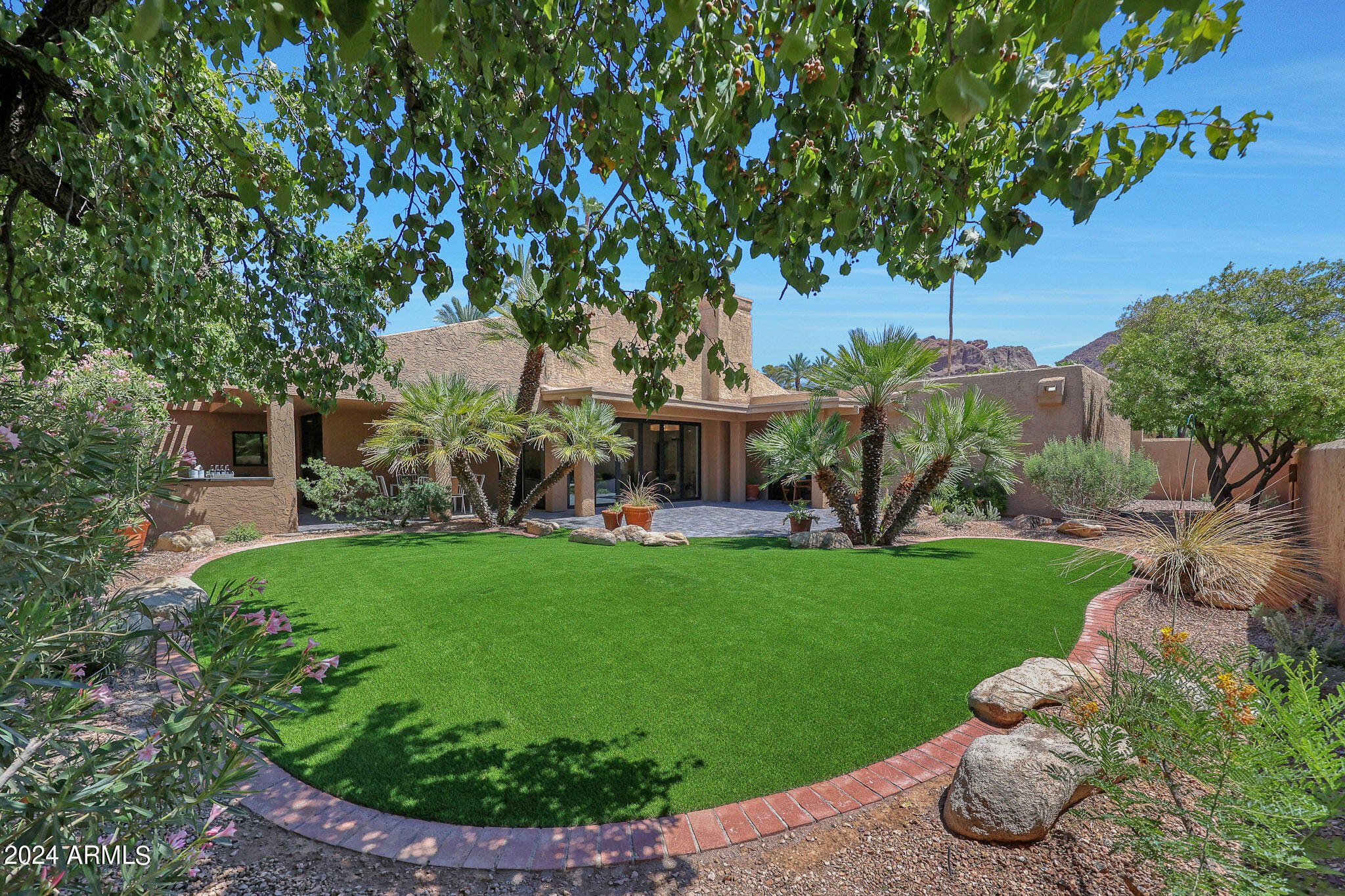 4440 East Camelback Road, Unit 32 Phoenix, AZ 85018 - Photo 43 of 54 a front view of a house with garden