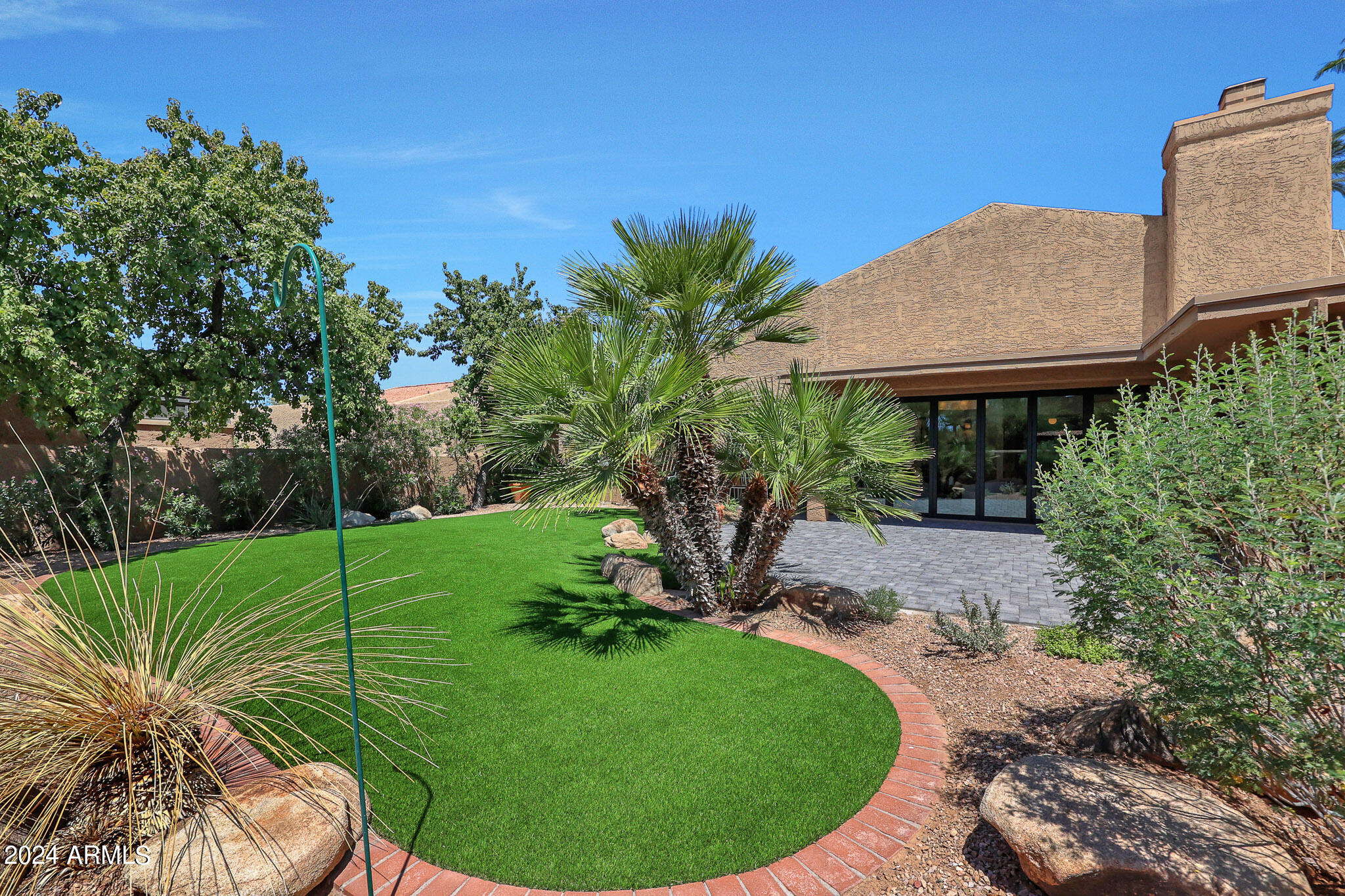 4440 East Camelback Road, Unit 32 Phoenix, AZ 85018 - Photo 44 of 54 a view of a backyard with plants and a patio