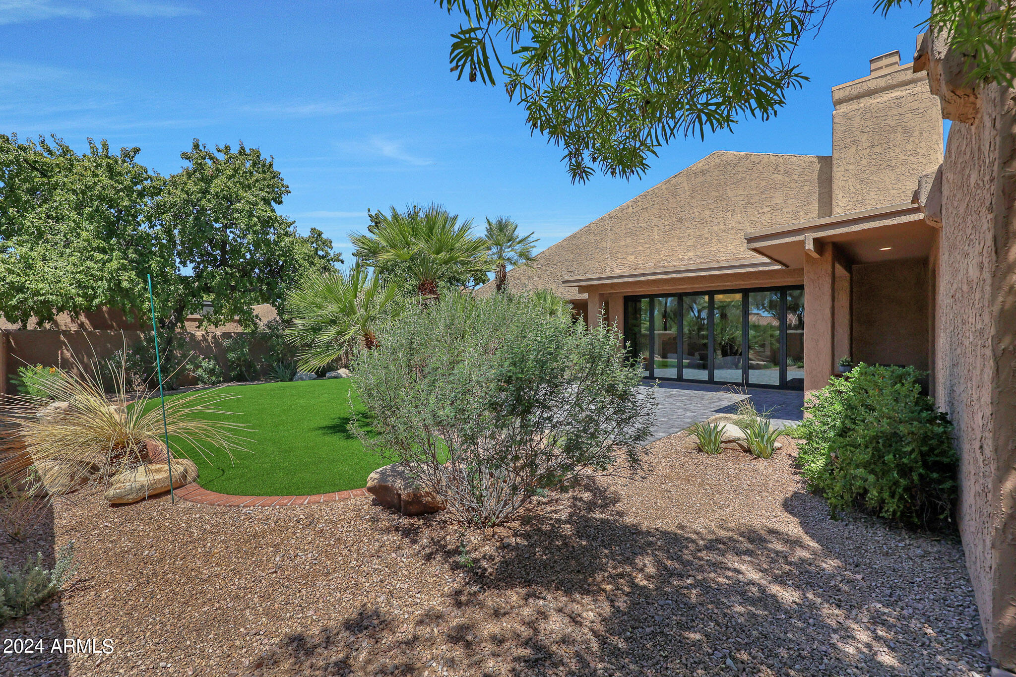 4440 East Camelback Road, Unit 32 Phoenix, AZ 85018 - Photo 45 of 54 a view of a chair and table in the garden