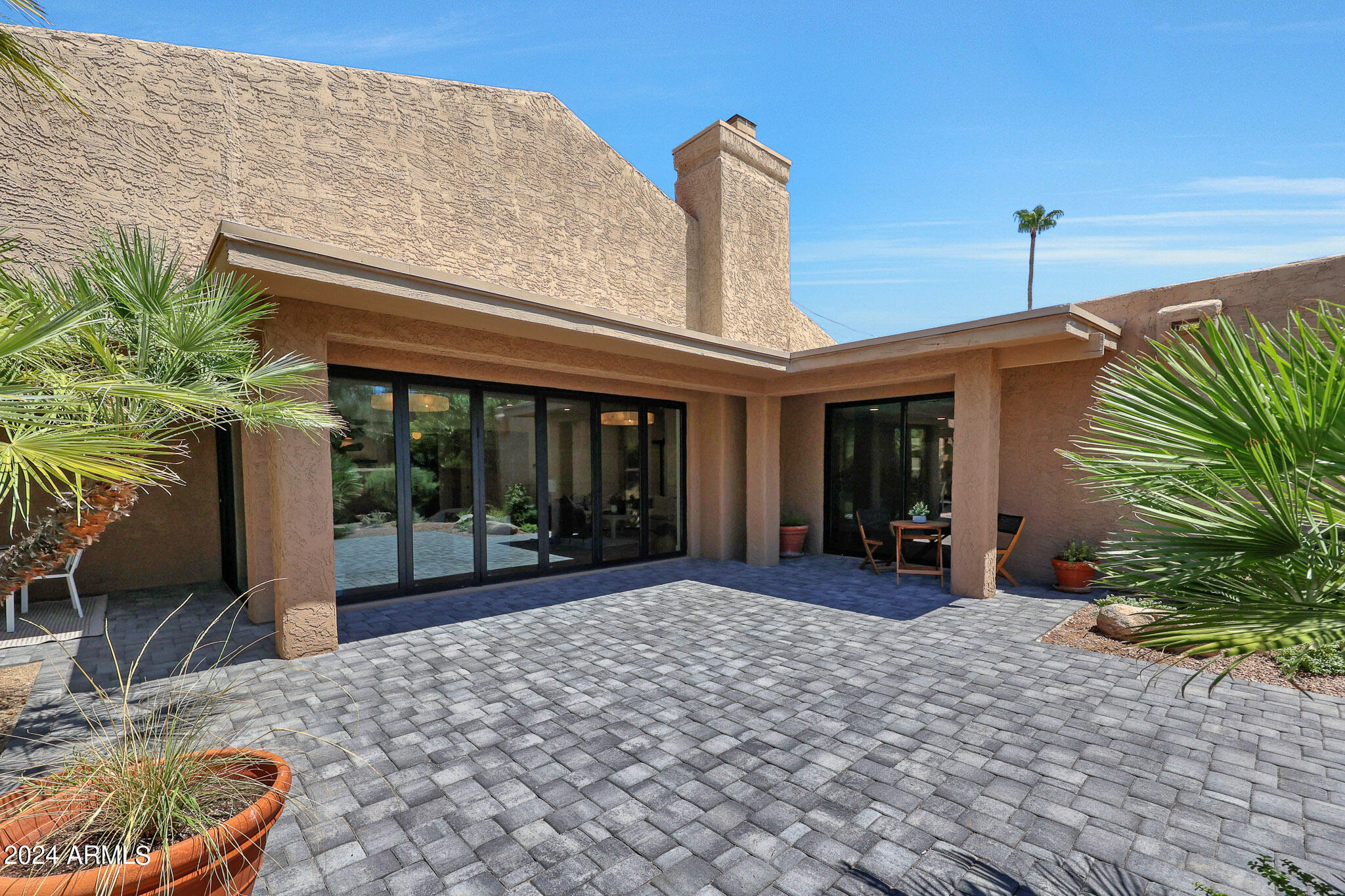 4440 East Camelback Road, Unit 32 Phoenix, AZ 85018 - Photo 46 of 54 a view of a patio with table and chairs potted plants