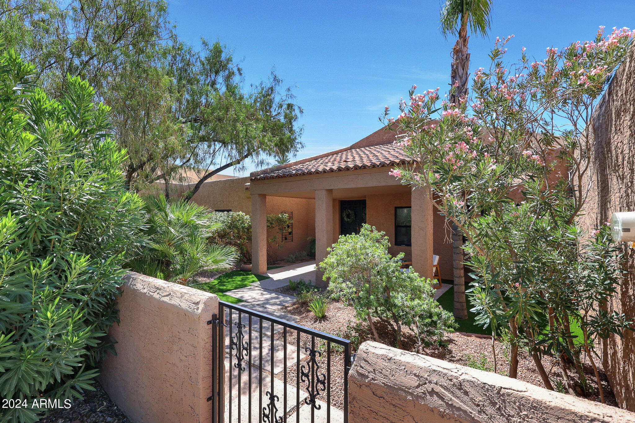 4440 East Camelback Road, Unit 32 Phoenix, AZ 85018 - Photo 5 of 54 a view of a house with a yard and potted plants