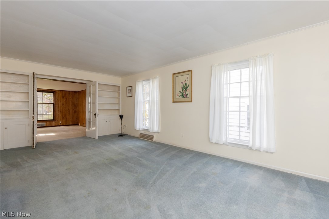 1050 Renfield Road Cleveland Heights, OH 44121 - Photo 7 of 41 Living Room with carpet flooring, multiple windows, and crown molding