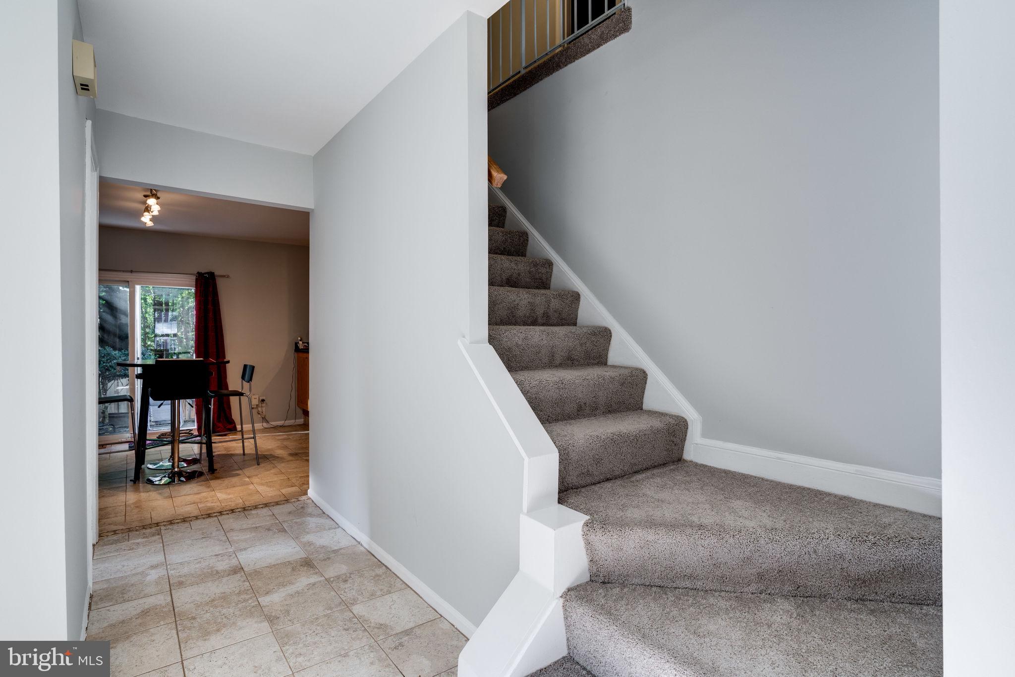 7909 Treeside Court Springfield, VA 22152 - Photo 3 of 35 Tile entryway, kitchen and new carpet on stairs