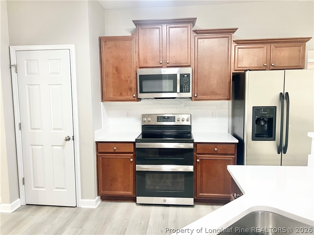 1523 Rough Rider Lane Parkton, NC 28371 - Photo 15 of 42 a kitchen with stainless steel appliances a stove microwave and refrigerator