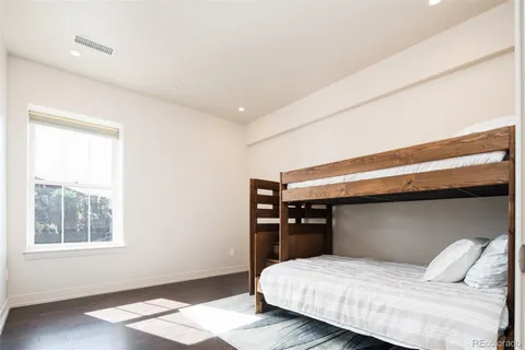a spacious bedroom with a bed and a window