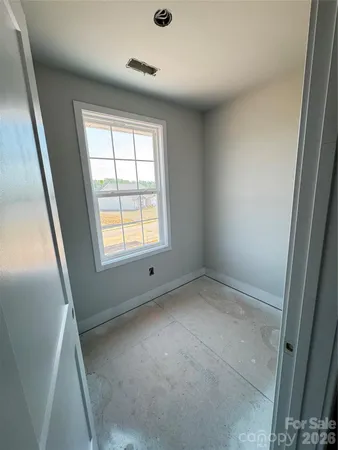 an empty room with a empty space and windows