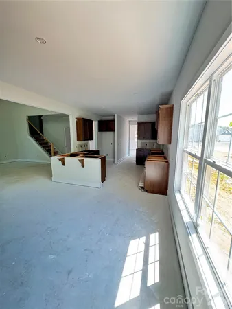 a living room with furniture and large windows