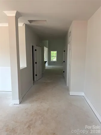 a view of a hallway with wooden shelves