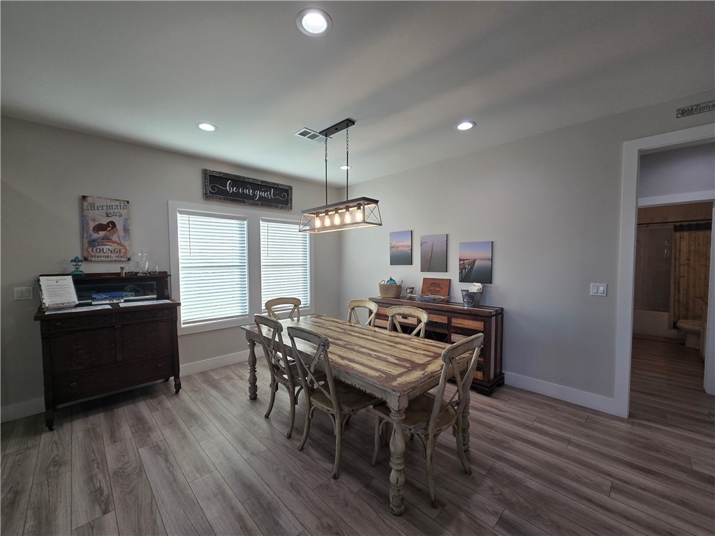 122 Ridge Harbor Drive Rockport, TX 78382 - Photo 19 of 34 a view of a dining room with furniture window and wooden floor