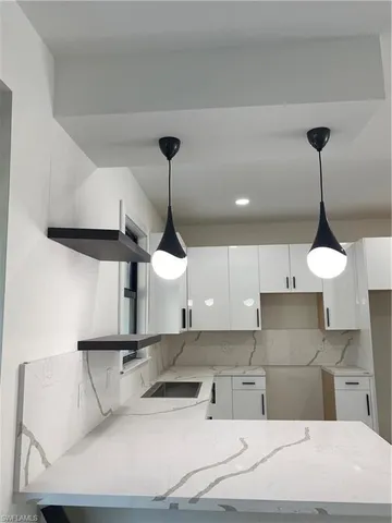 a kitchen with stainless steel appliances granite countertop a sink a stove and a refrigerator