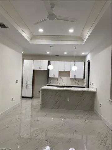 a view of living room with a fireplace and cabinets