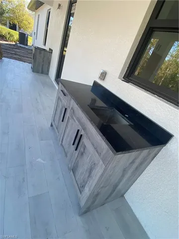 a living room with furniture a sink and a refrigerator