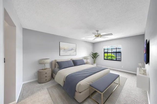 an empty room with a window and a ceiling fan